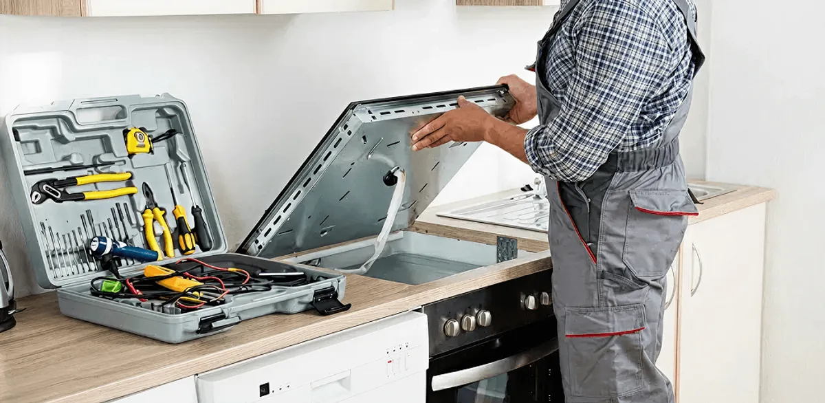 Handyman repairing a cooktop and checking wiring connections in Anaheim, CA