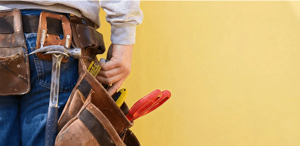 Handyman with tool belt ready for home repairs and maintenance in Anaheim, CA