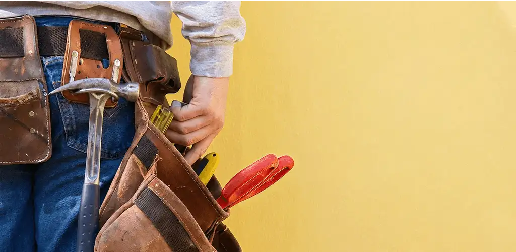 Handyman with tool belt ready for home repairs and maintenance in Anaheim, CA