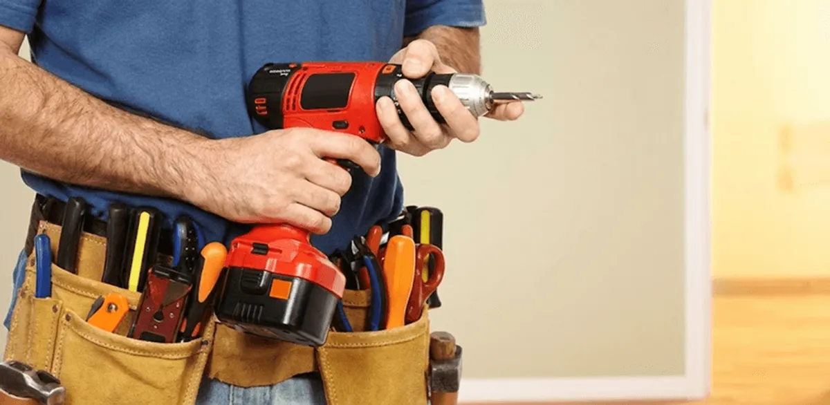 Handyman holding a power drill for home repairs and installations in Anaheim, CA