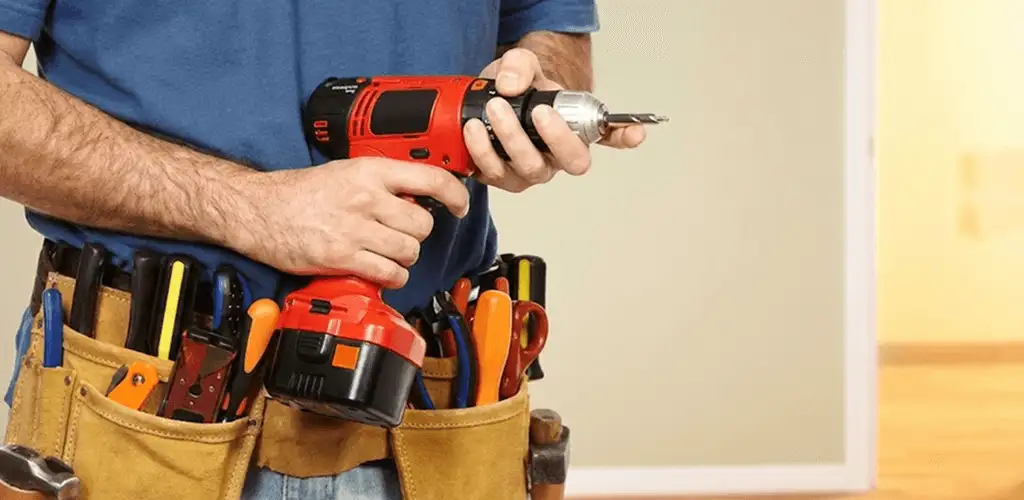 Handyman holding a power drill for home repairs and installations in Anaheim, CA