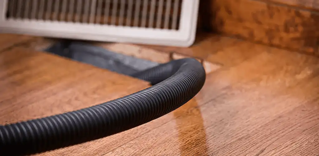 Air duct cleaning hose inserted into a floor vent for ductwork cleaning in Anaheim, CA