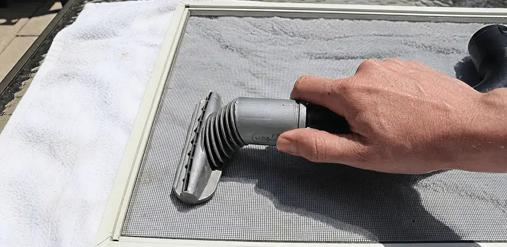 Window screen repair cleaning and fixing a damaged screen mesh in Anaheim, CA
